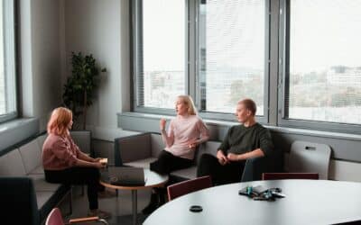 2 women sitting on black sofa