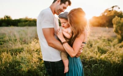 family photo on green grass during golden hour