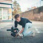 Man filming with a professional camera on the street