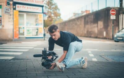 Man filming with a professional camera on the street