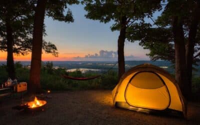 a tent set up in the woods at sunset