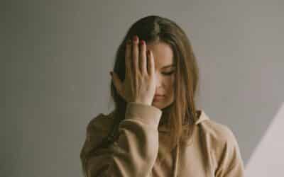 a woman covering her face with her hands