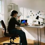 Person working at desk with laptop and phone