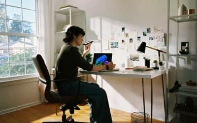 Person working at desk with laptop and phone